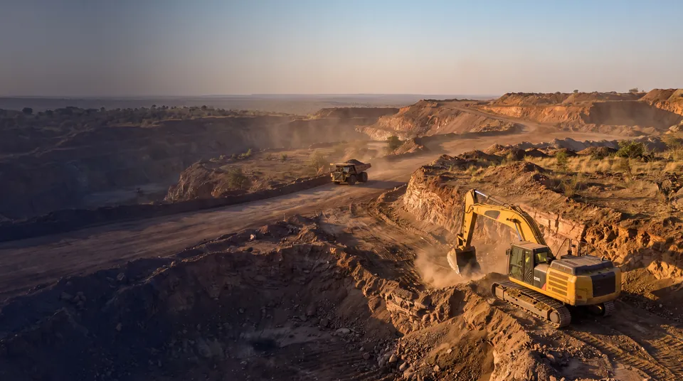 Excavator loading ore at an open-pit mine