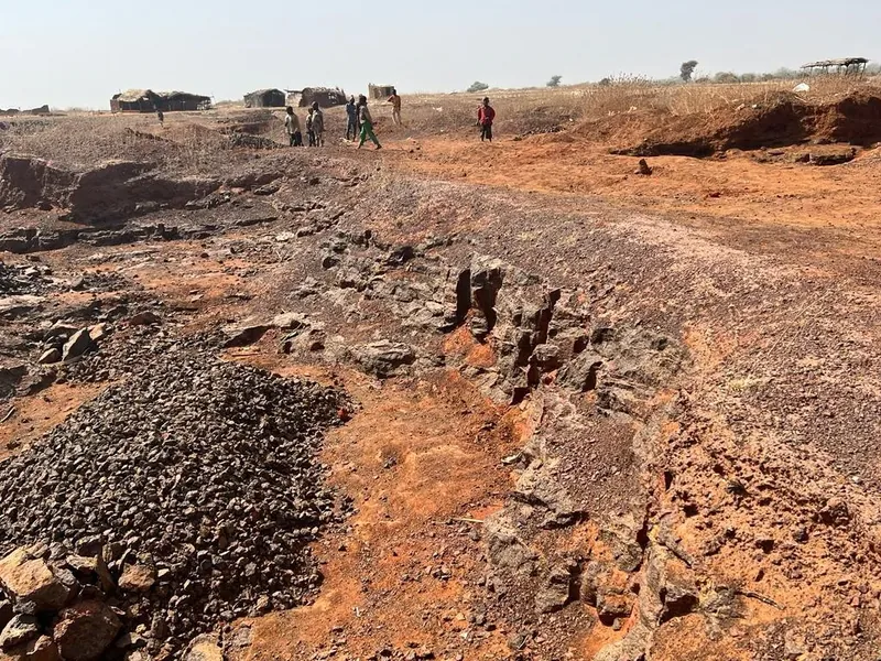 Exploration trench cut through red laterite