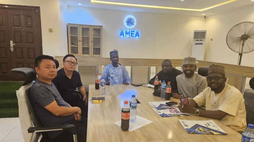 AMEA boardroom at the Kano office, with partners around the table beneath the AMEA sign