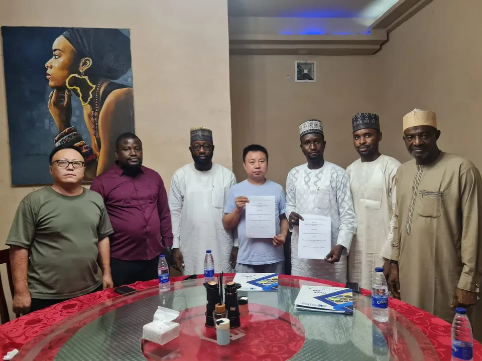AMEA team and partners holding signed agreements